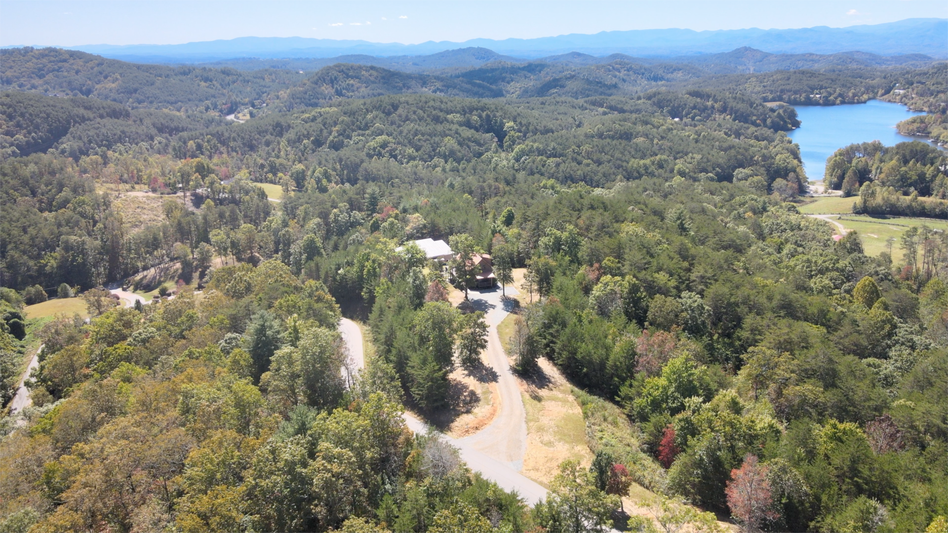 Aerial view of Eagle's Nest Retreat near the surrounding lake and mountains